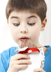 Image showing Surprised boy with chocolate