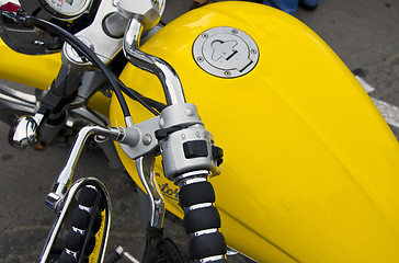 Image showing Motorcycle wheel and yellow petrol tank details.