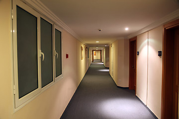Image showing A long hotel corridor