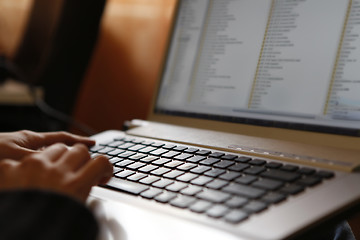 Image showing Young woman working on laptop