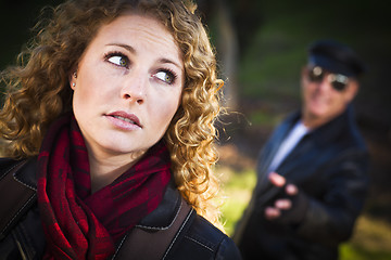 Image showing Pretty Young Teen Girl with Man Lurking Behind Her