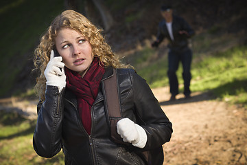 Image showing Pretty Young Teen Girl Walking with Man Lurking Behind Her