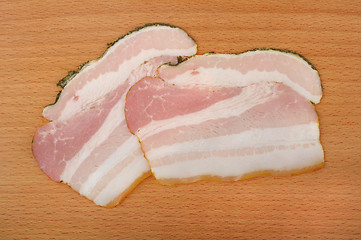 Image showing sliced bacon on a wooden cutting board