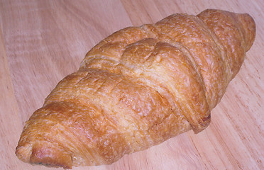 Image showing croissant on a wooden board