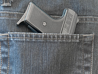 Image showing pocket with pistol