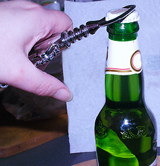 Image showing opening a bottle