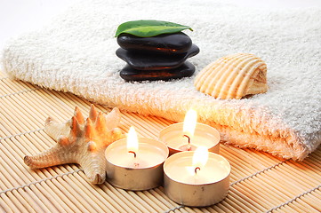 Image showing foldet white bath towel and zen stones