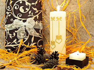 Image showing  festive composition with gift, candle and cones 