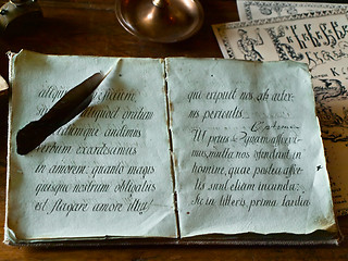 Image showing Old write book and feather