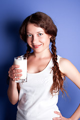 Image showing young woman enjoying a glass of milk 