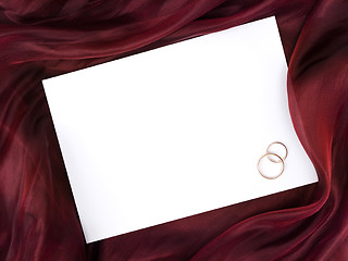 Image showing white frame in silk and two wedding rings 