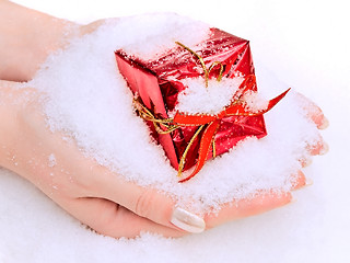 Image showing hands with gift in snow