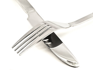 Image showing Crossing knife and fork against white