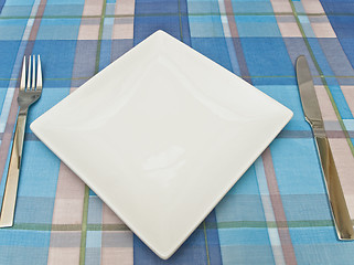 Image showing dish with fork and knife at tablecloth