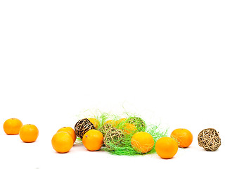 Image showing mandarines and golden balls with green