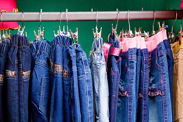Image showing Denim pants on a hanger for children in the store