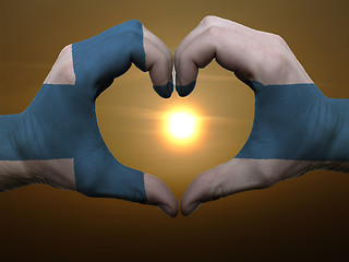 Image showing Heart and love gesture by hands colored in finland flag during b