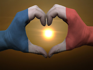 Image showing Heart and love gesture by hands colored in france flag during be