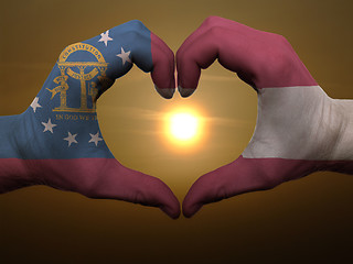 Image showing Heart and love gesture by hands colored in georgia flag during b