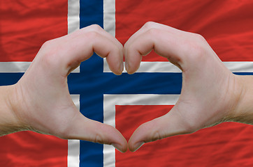 Image showing Heart and love gesture showed by hands over flag of norway backg