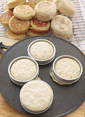 Image showing Baking crumpets on a griddle