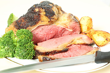 Image showing Roast sirloin beef joint with knife
