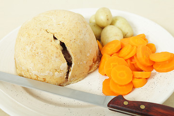 Image showing Steak and kidney pudding ready to serve