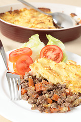 Image showing Shepherds pie with serving dish vertical