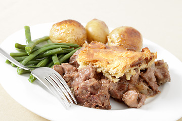 Image showing Steak and kidney pie with fork