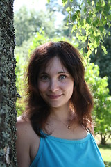 Image showing Brunette standing beside a birch