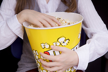 Image showing hand in a bucket of popcorn
