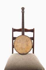 Image showing Antique Banjo On Antique Chair