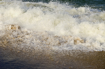 Image showing Waves carrying sea sand on shore.