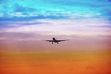 Image showing Passenger plane takes off at sunset