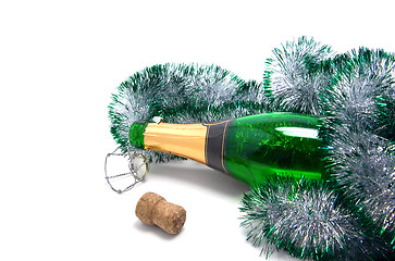 Image showing Empty bottle of champagne and Christmas tinsel 