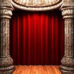 Image showing red velvet curtains behind the stone columns