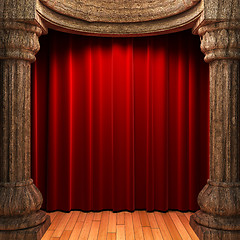 Image showing red velvet curtains behind the old wood columns