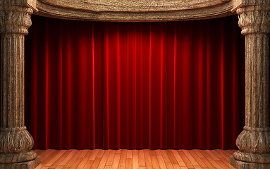 Image showing red velvet curtains behind the old wood columns