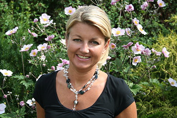 Image showing Autumn anemones with a blonde in front