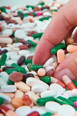 Image showing hand grabbing pills