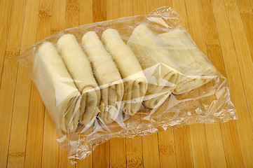 Image showing package frozen pancakes on a wooden table