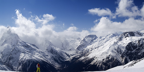 Image showing Panorama Caucasus Mountains. Slope with skier. 