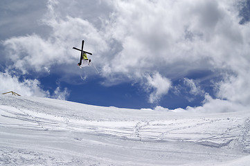 Image showing Freestyle ski jumper with crossed skis