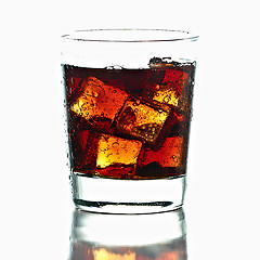 Image showing Fresh Cold Cola with ice in glass isolated on white background