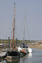 Image showing tall boats at low tide