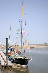 Image showing tall boats at low tide