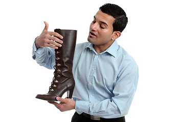 Image showing Shoe salesman showing women's boot