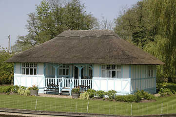 Image showing thatched cottage next to the river