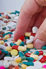 Image showing hand grabbing pills