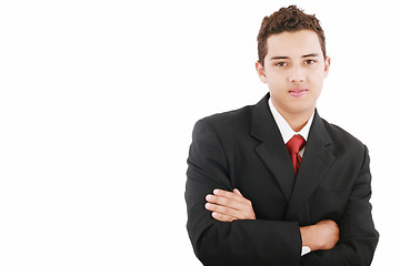 Image showing Young business man standing against the wall with crossed arms 